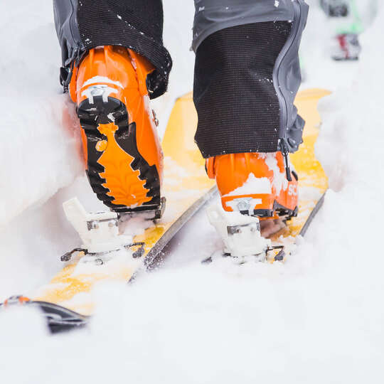 Orange Ski Boots Ski Touring closeup at Purcell Mountain Lodge